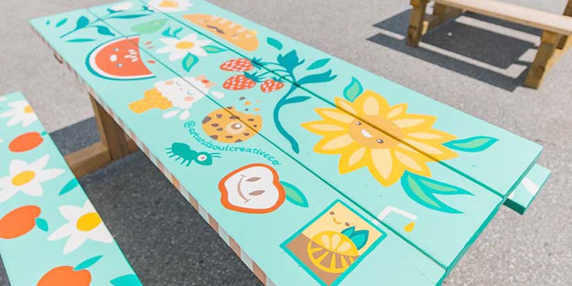 Artists have a picnic painting pop-up tables
